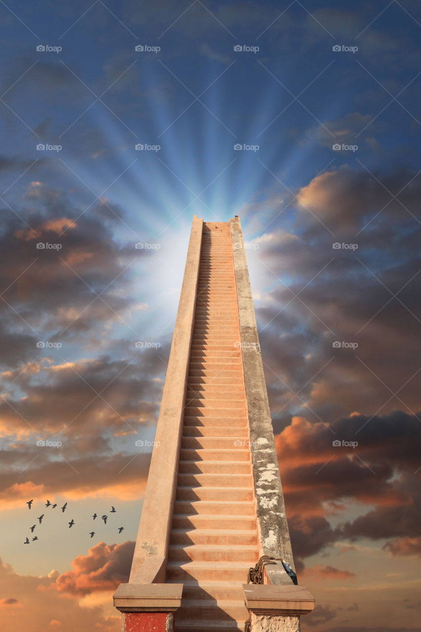 Staircase to success / reach the top concept photo with beautiful clouds in the background