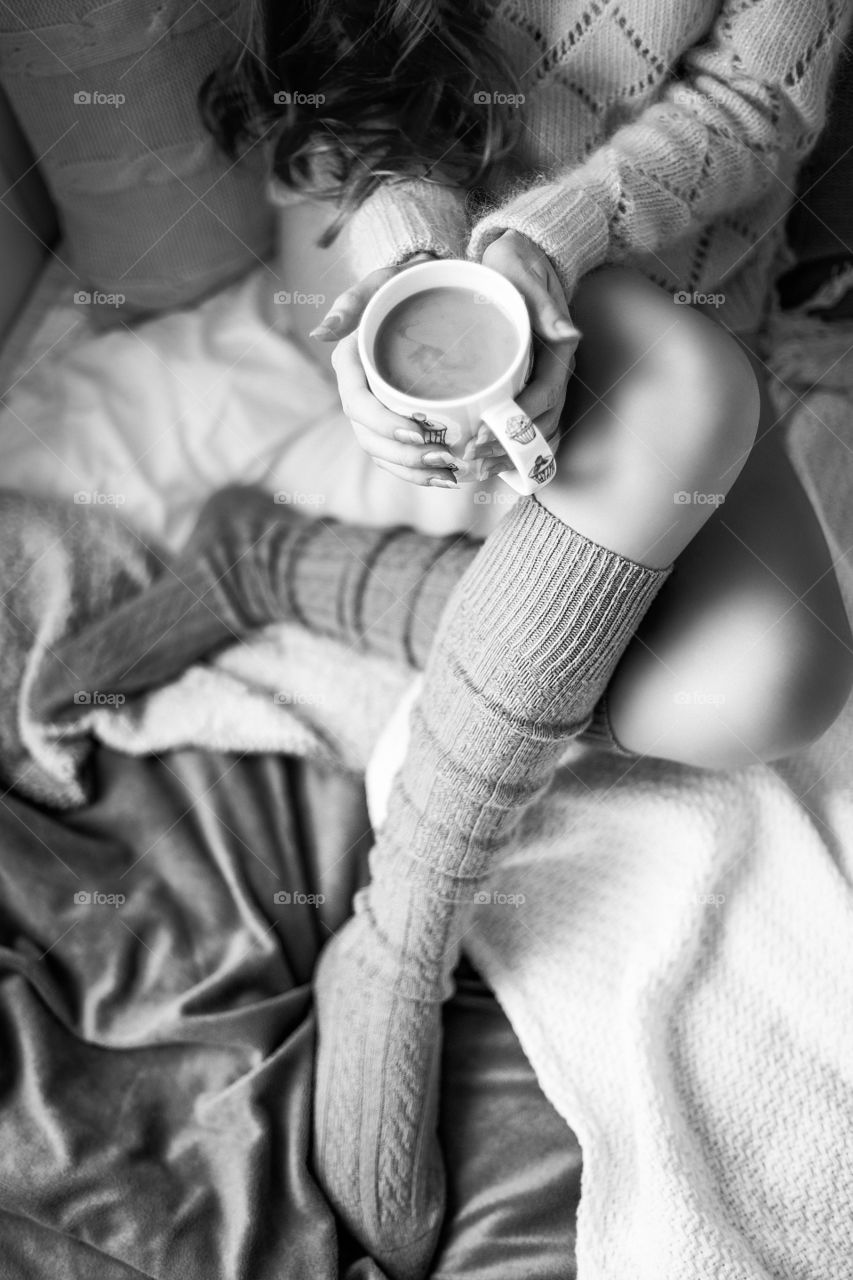 Cozy autumn evening with hot chocolate in a bed, black and white photo