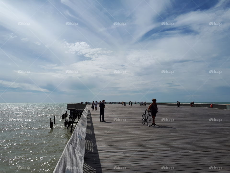 people walking on Hastings pier in summer