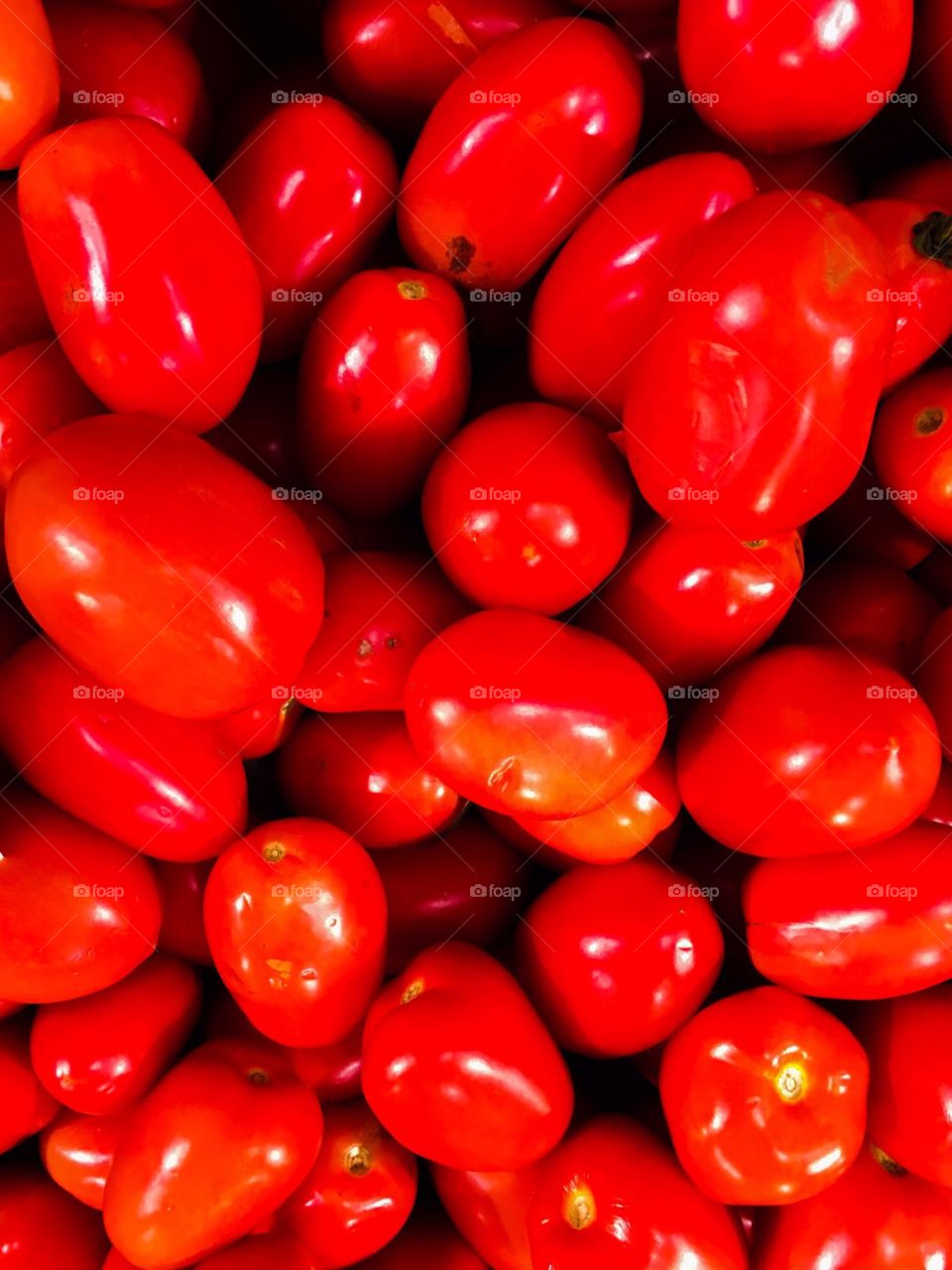 Shiny red Roma tomatoes in the produce department. 
