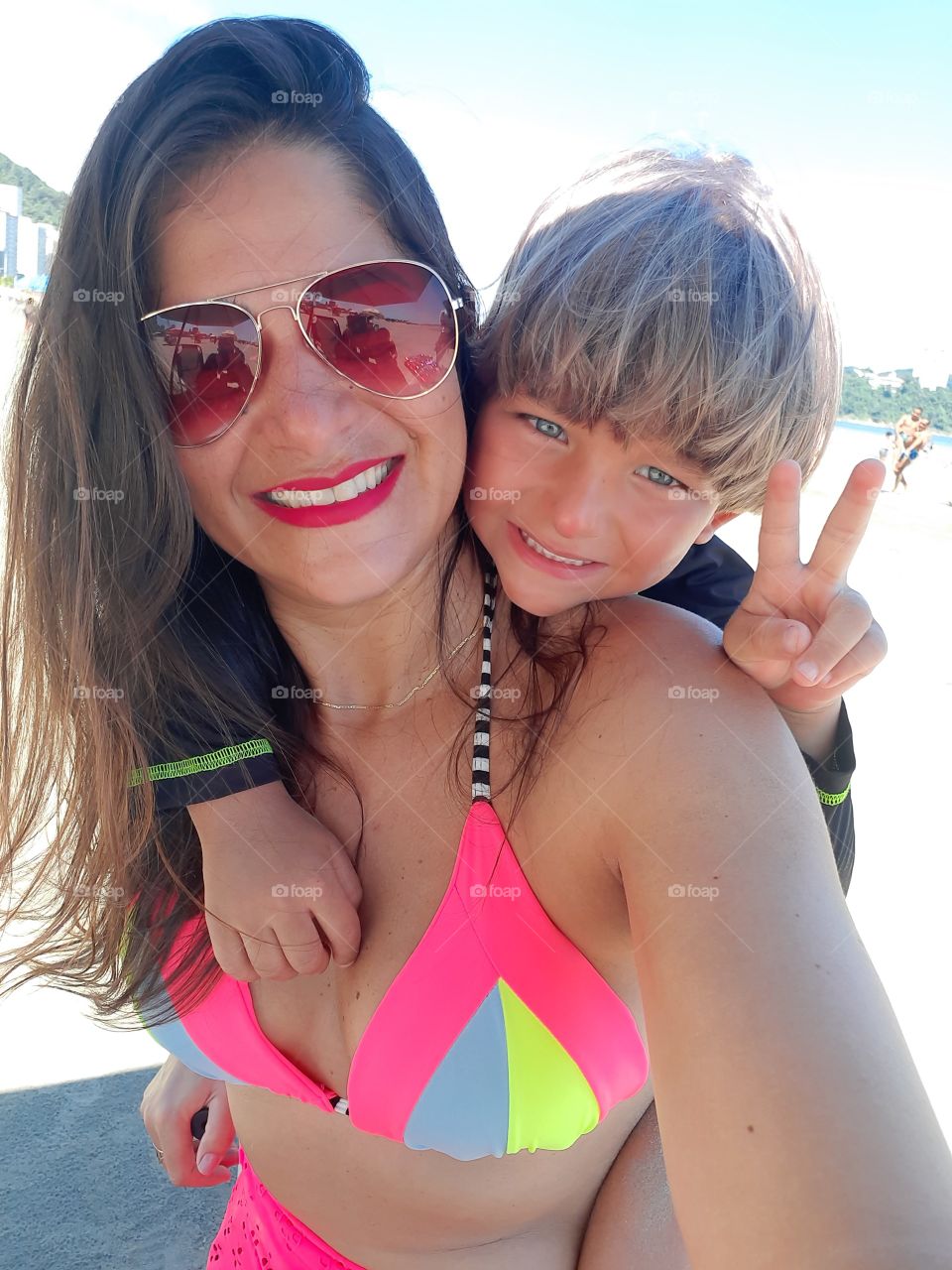 smiling woman and child on the beach