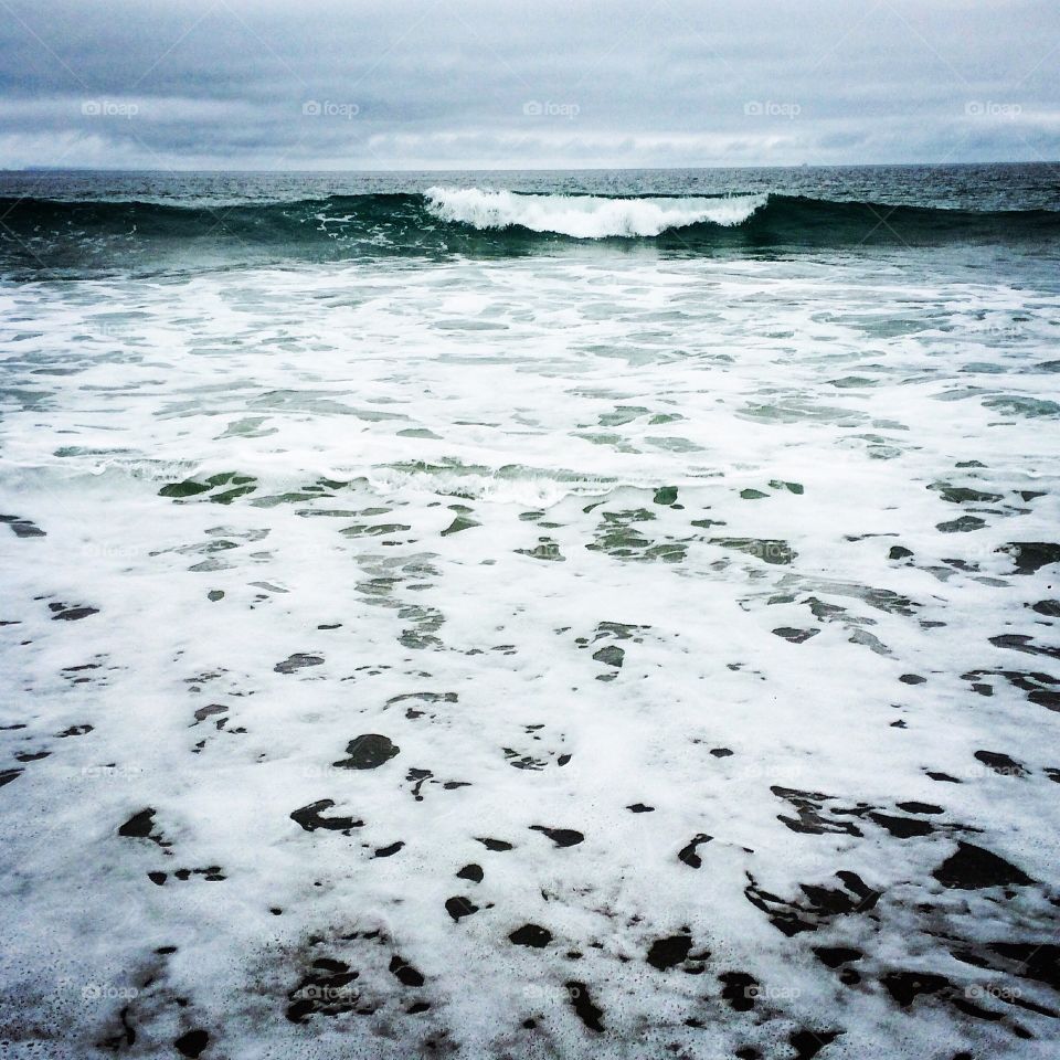 Surf on Malibu Beach in California. It was a stormy day and the water was a bit chilly
