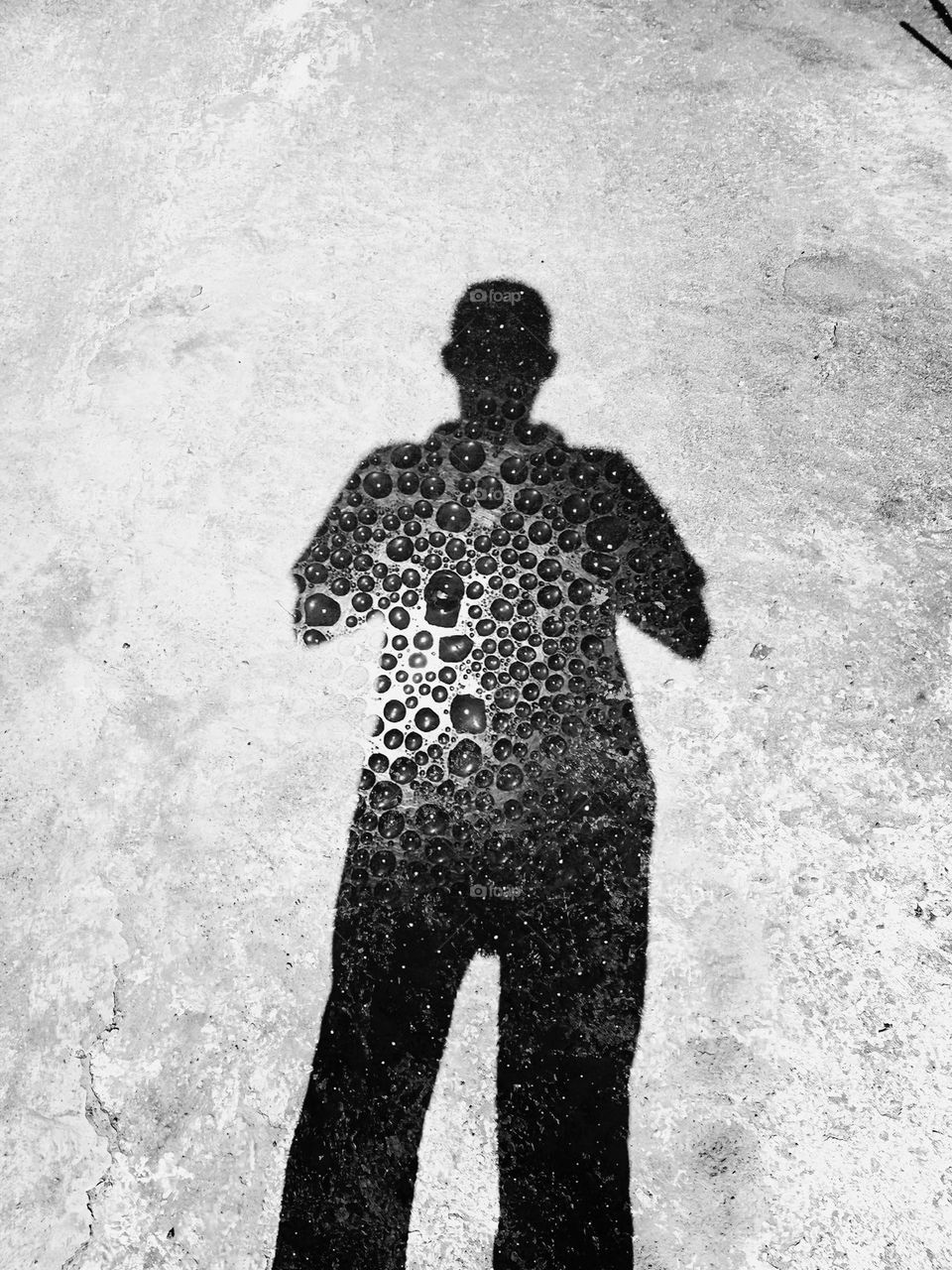 Drops of water on a man shadow