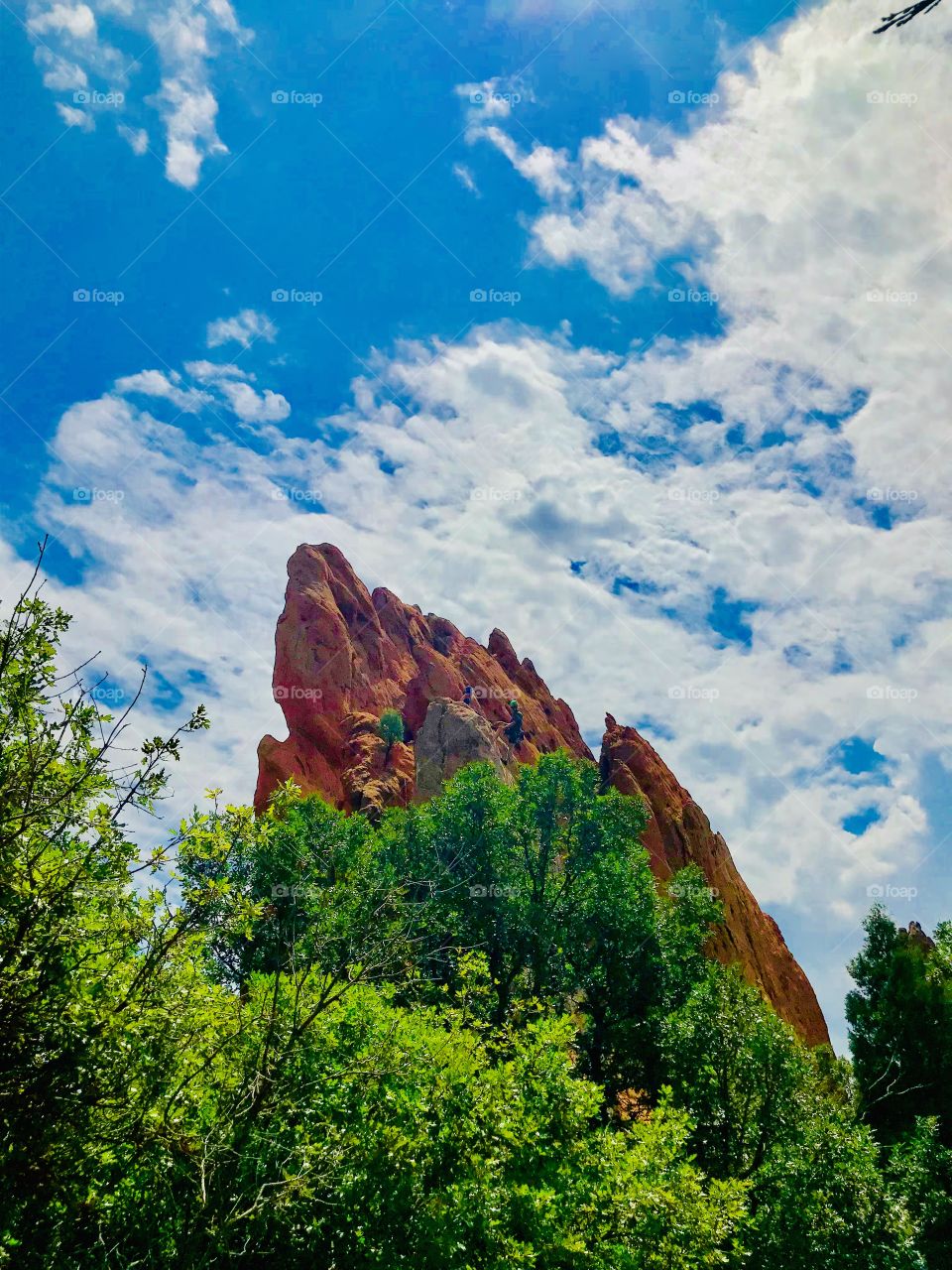 Rock climbers on top of a rock formation at Garden of the Gods. There are beautiful spots throughout the park for a climb