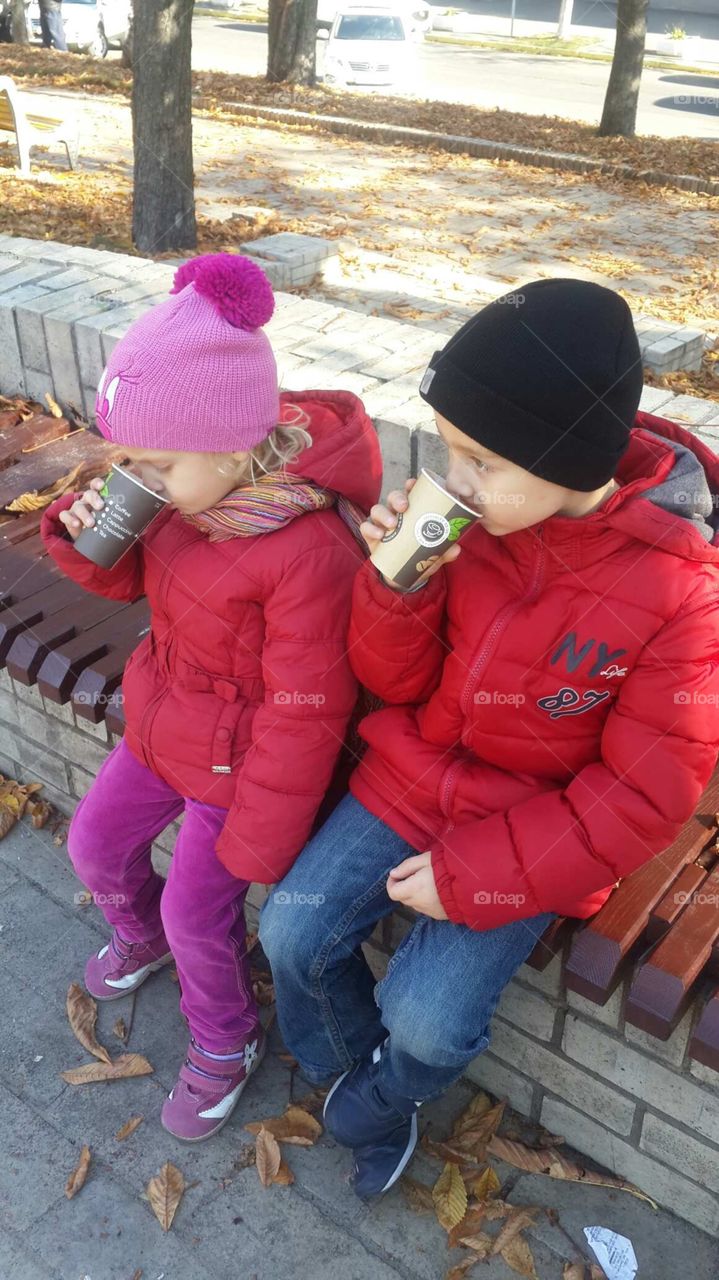 Children drinking hot chocolate in fall