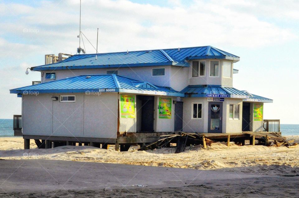 Aftermath of Hurricane Sandy. Boardwalk ripped away, free standing destroyed bathroom, shower building