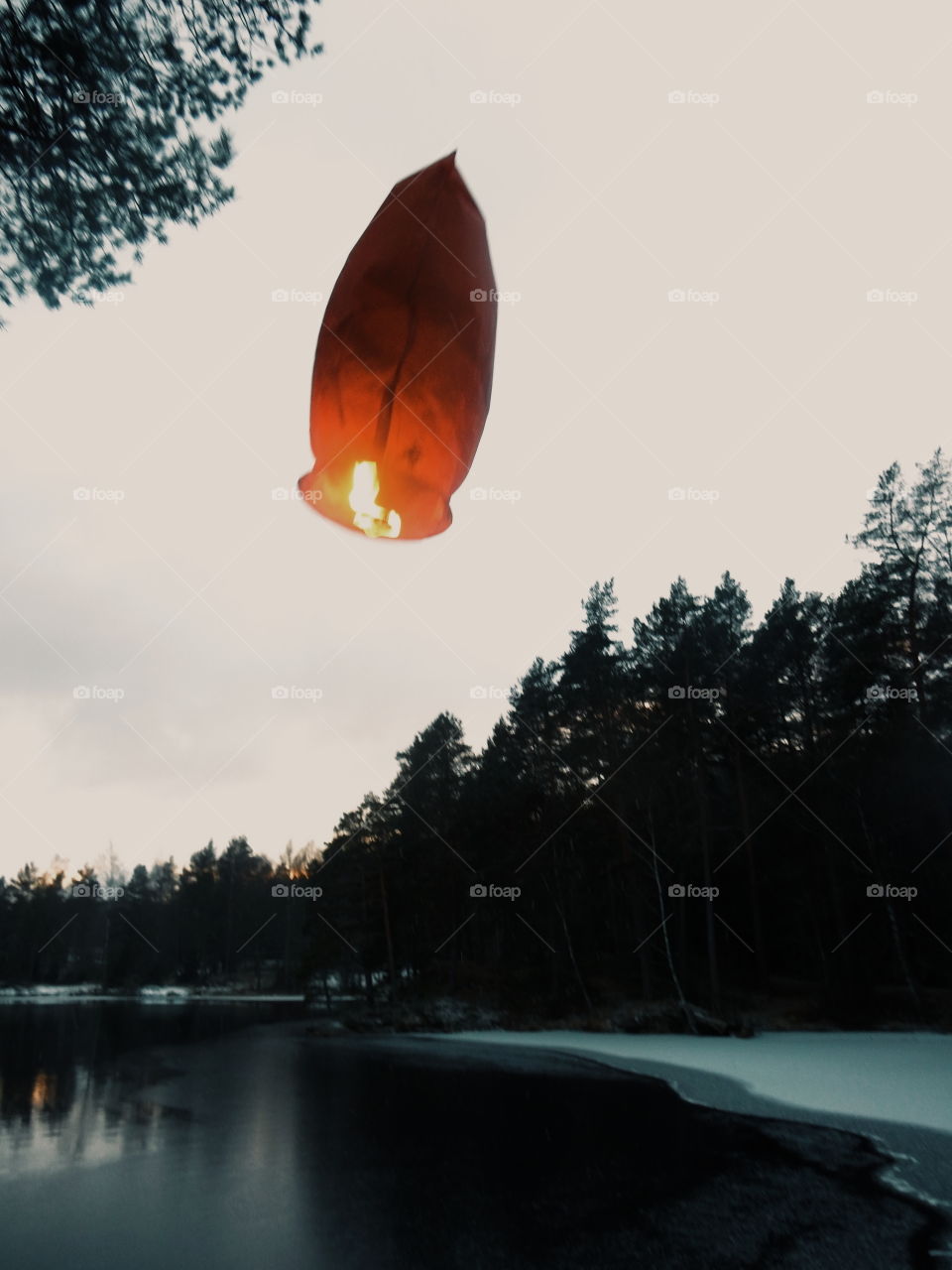 Sky lantern flying against sky