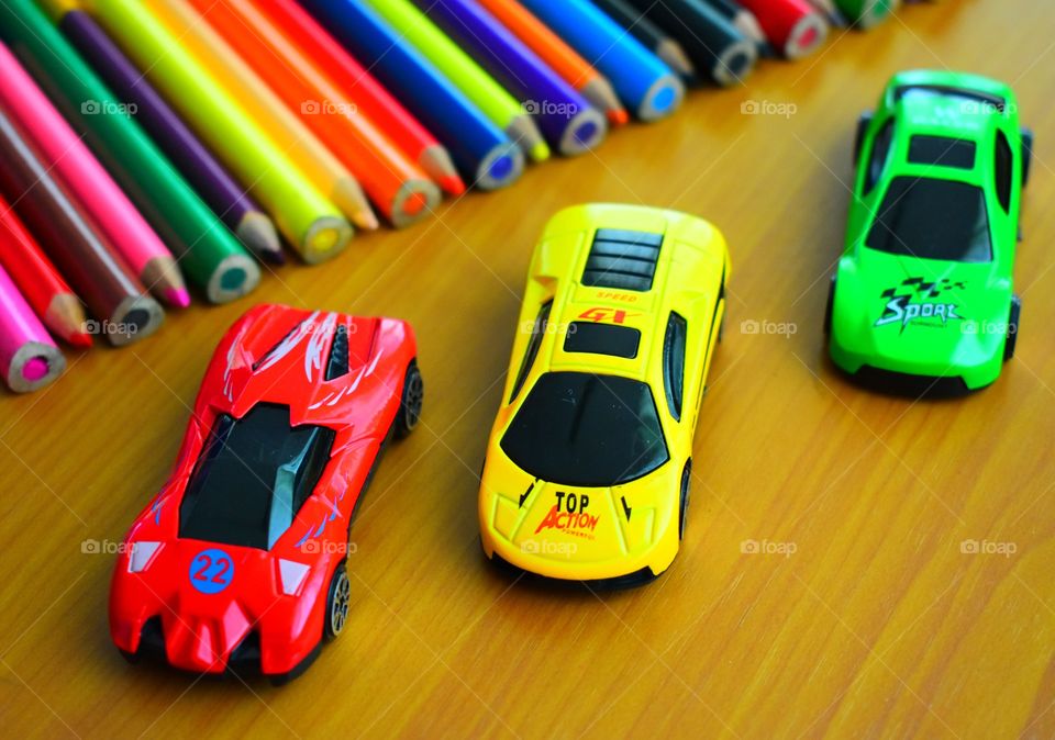 Colorful toy cars with color pencils