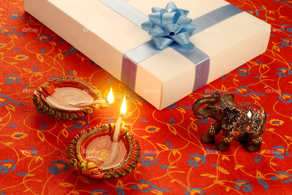 Beautiful Diwali set up with a gift box, diya oil lamps