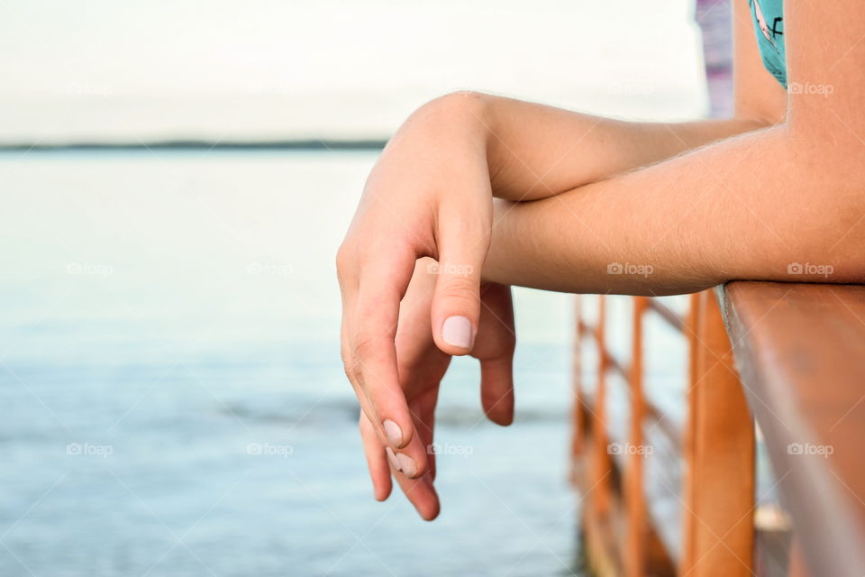 Hands of a girl on the beach