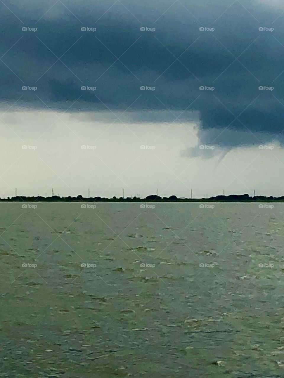 Funnel cloud forming off the coast over pirates beach in Texas. 