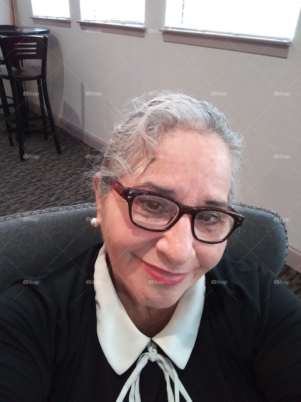 professional woman, older woman, wears eye glasses, grey