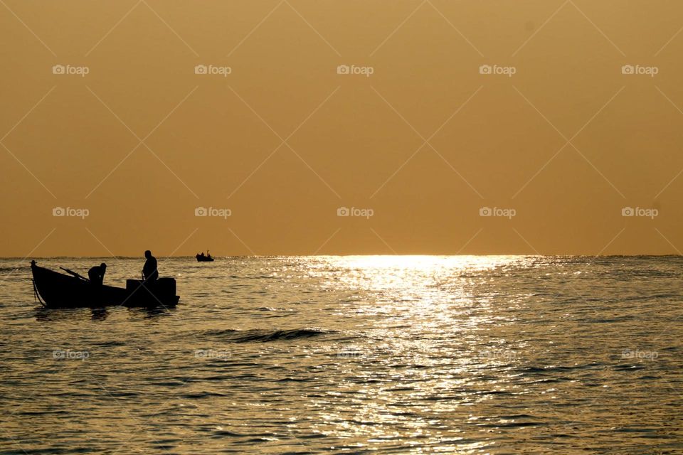 Fishermen boat at sunset 