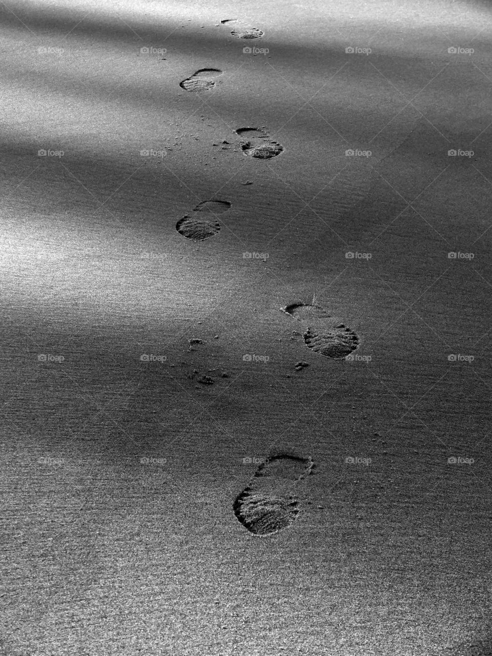 High angle view of footprints on beach.