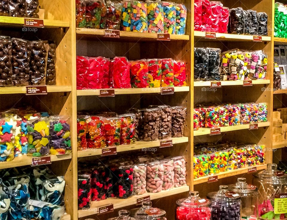 Shelves full of colorful candy in bag, jars, and boxes