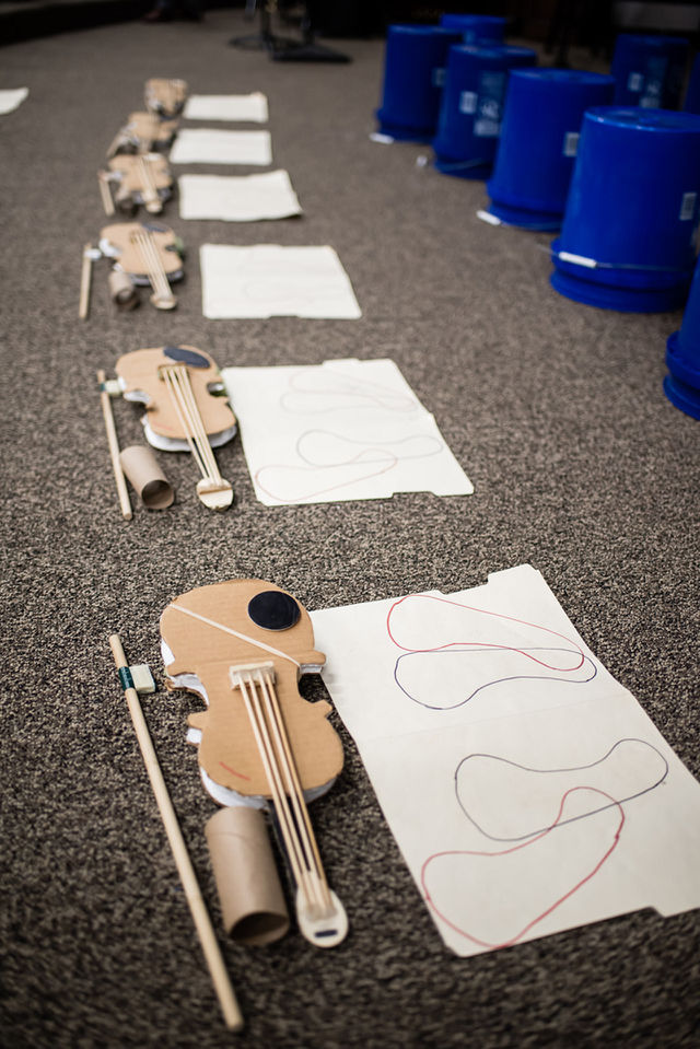 Practice paper violins at an elementary school 