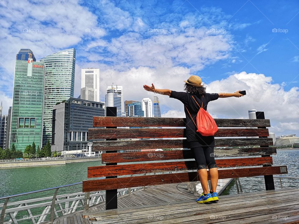 Woman's arms back Singapore skyline