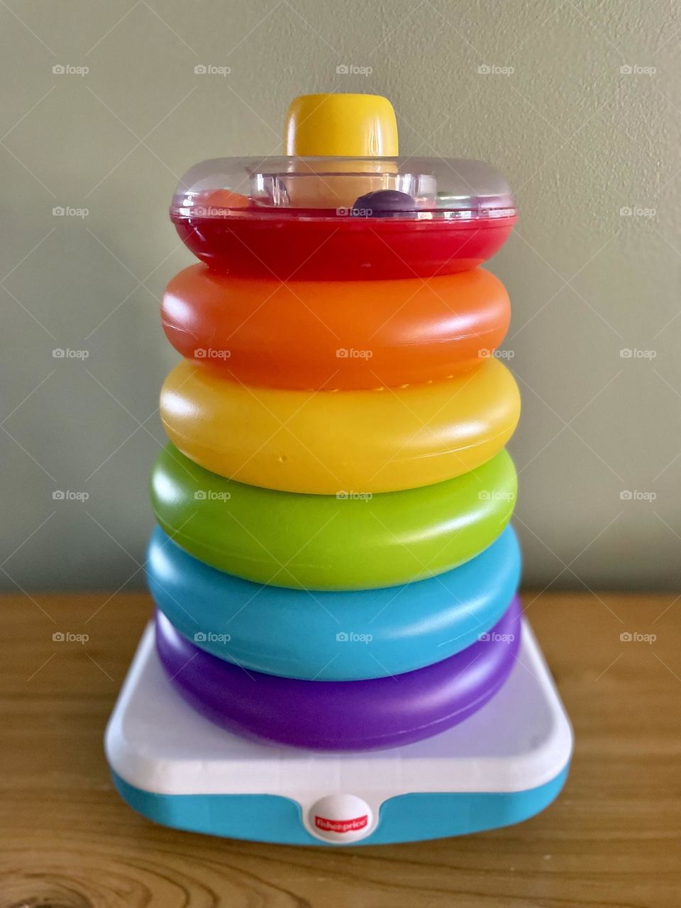 Infant stacking toy in circle shapes, circular stacking toy for babies, rainbow circles, rainbow stacking toy for infants, geometric shapes in everyday life, stacking circles 