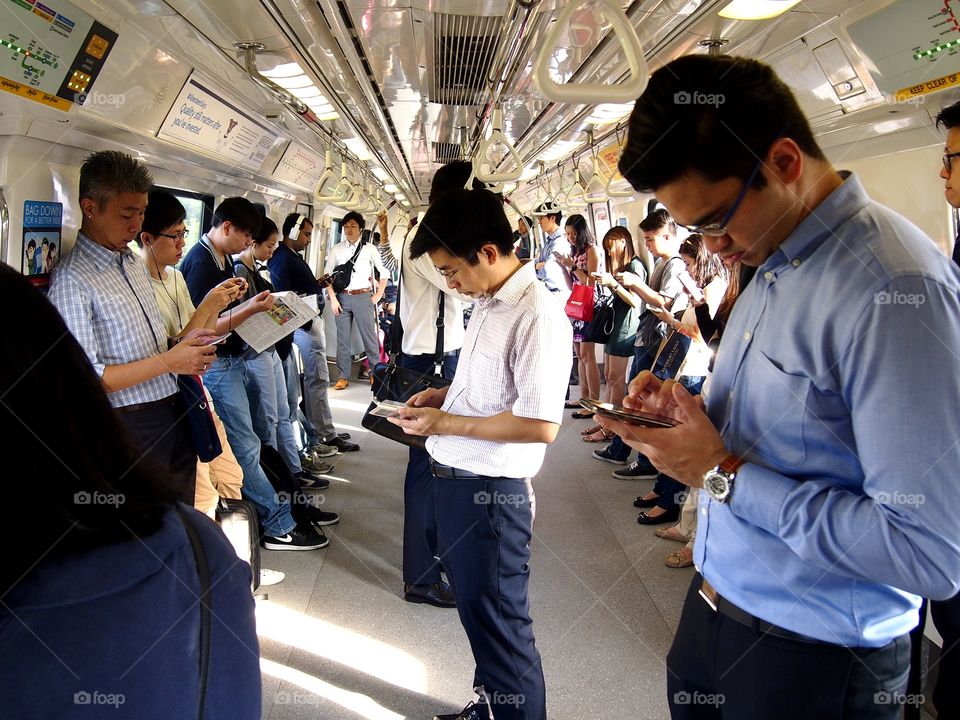 passengers inside a train using smartphone or cellphone