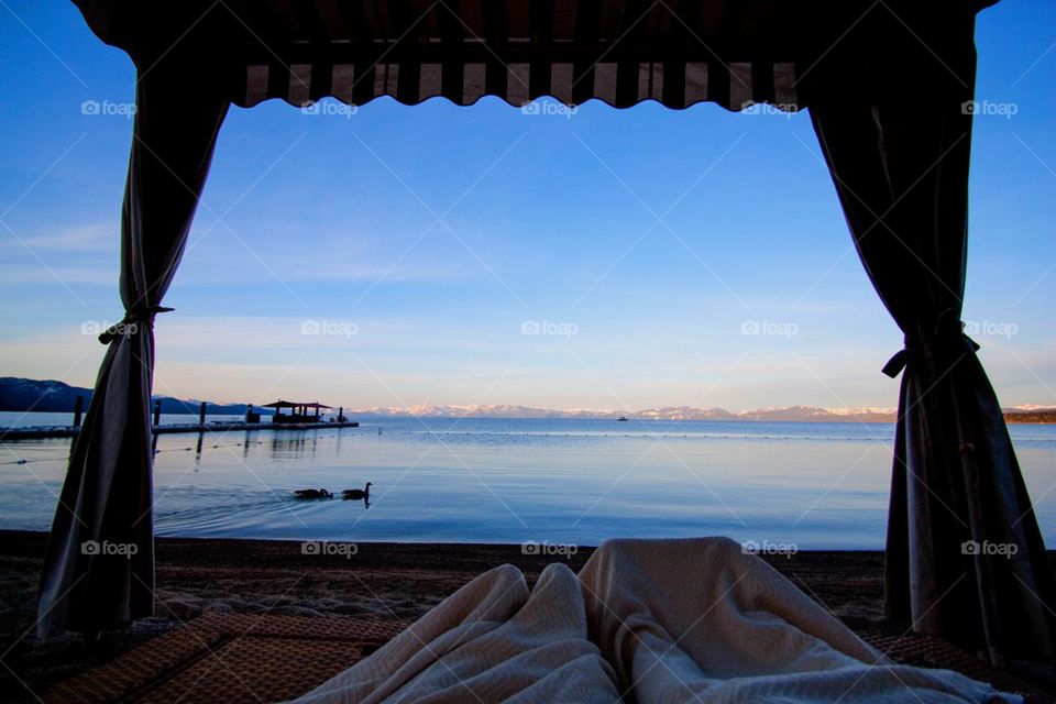 Low section of person relaxing on lake