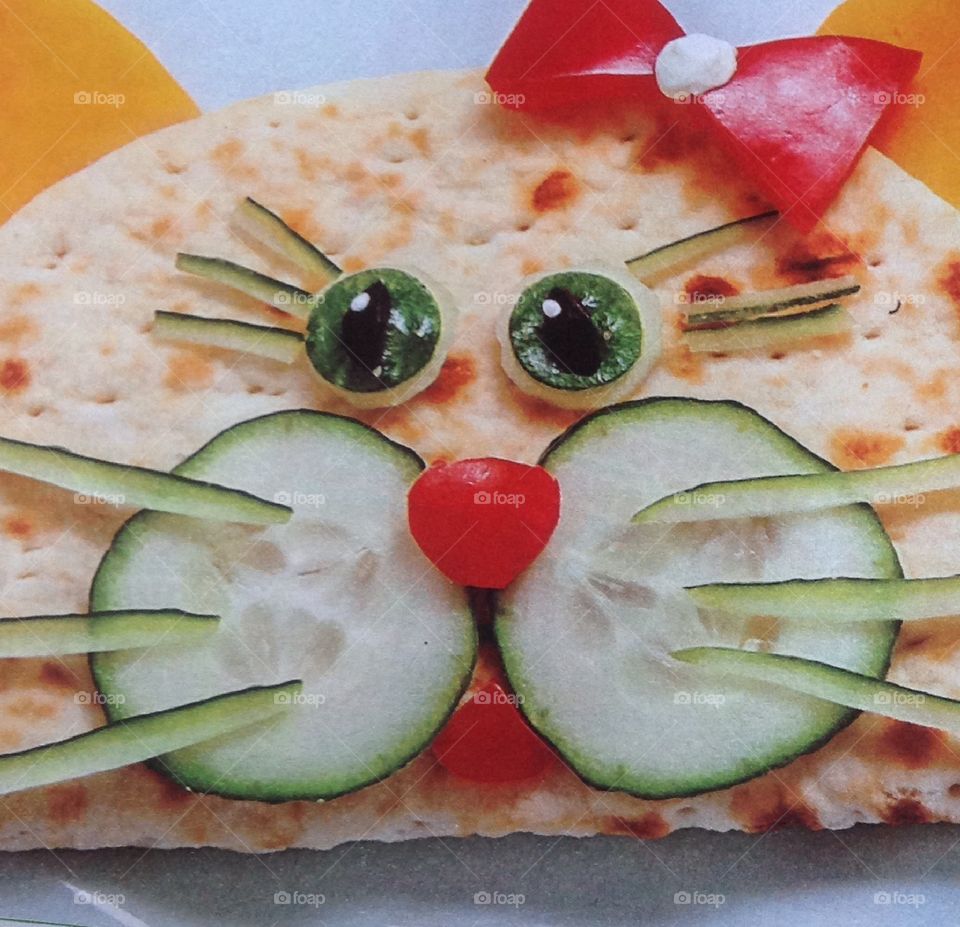 Quesadilla with a happy face made from cucumbers and peppers for lunch or dinner.