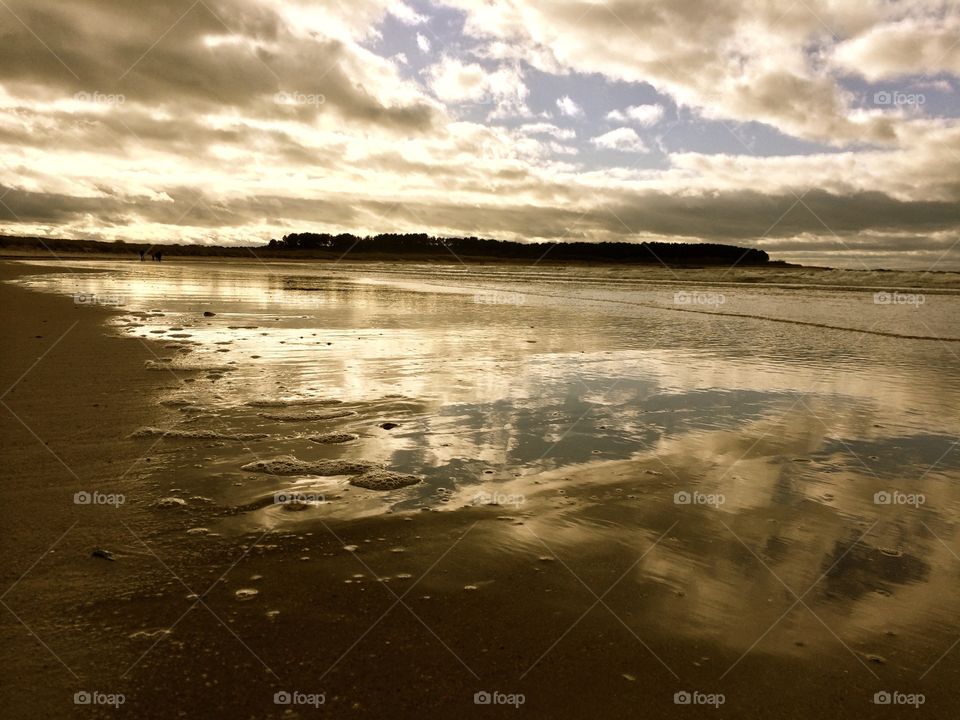 Cloudy sky reflected on sea