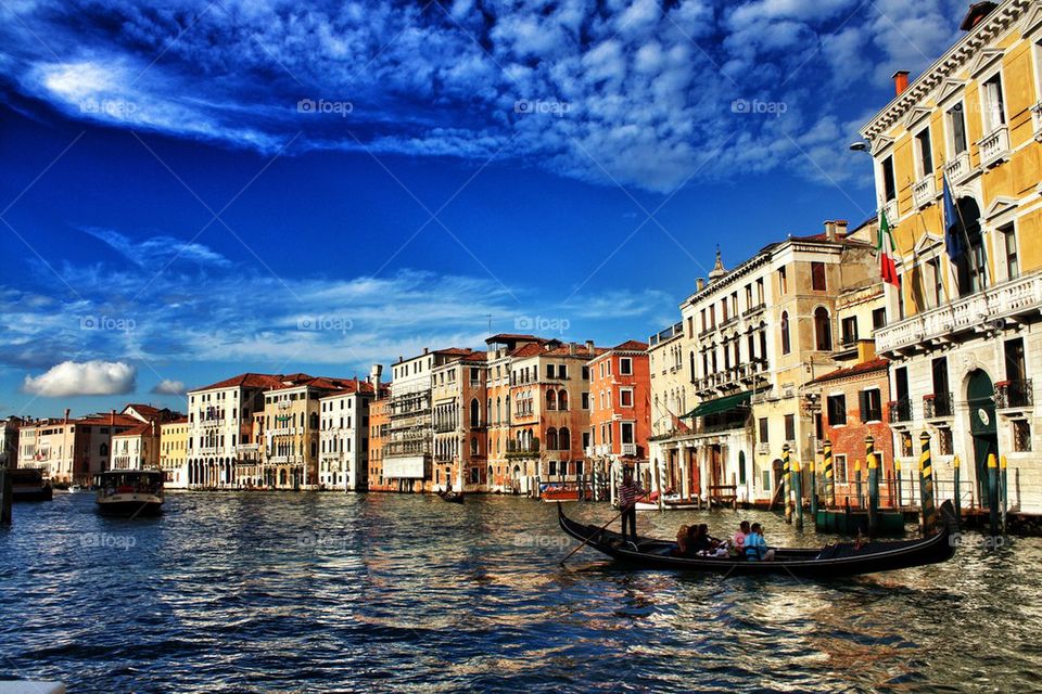 Boats in canal along buildings