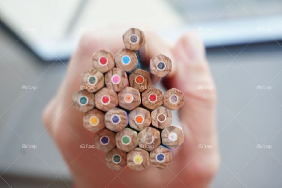 Holding colorful pencils