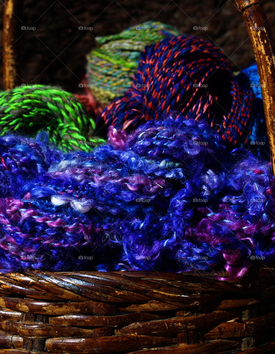 A colorful basket filled with hand dyed and hand spun yarn from wool. 