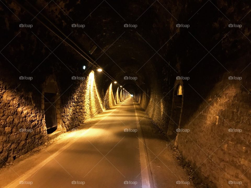 In the tunnel is illuminated with yellow light, creating a beautiful dark and light, very few people pass by. mostly during the bike tour would pass it