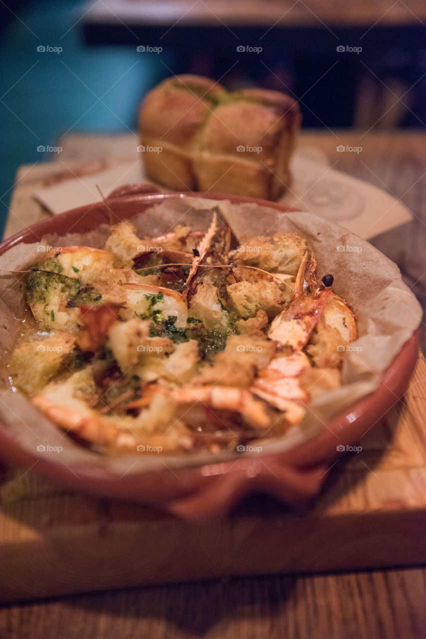 An appetizer of shrimp and bread on restaurant Jamie's Italian in London.