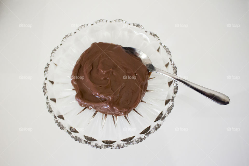 Chocolate pudding on glass dish with spoon 
