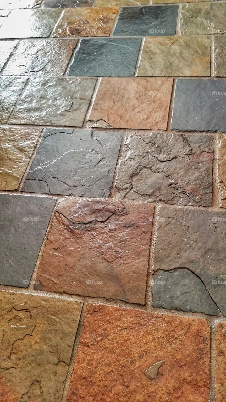 Slate floor tiles. The lacquered sheen accentuates the variety of colors and textures.