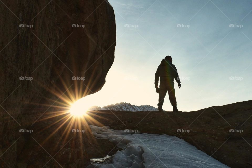 silhouette of single man standing on top