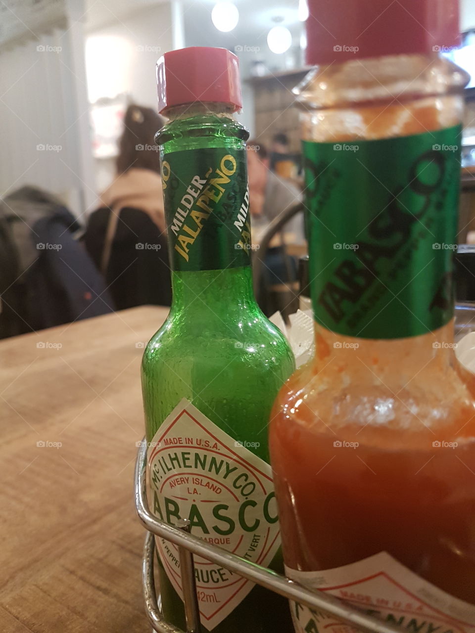 Two tabasco bottles on a table during a saturday brunch. Montréal, Québec, Canada.