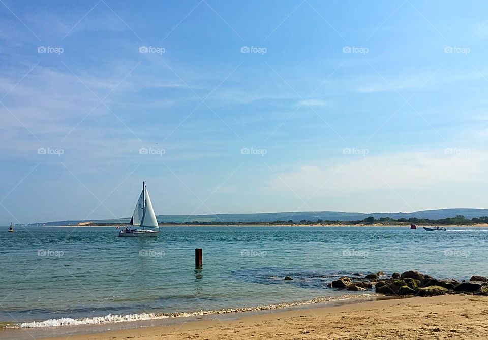 Boat Sailing Past The Beach