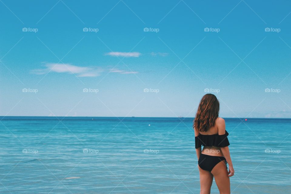 Girl standing in the ocean