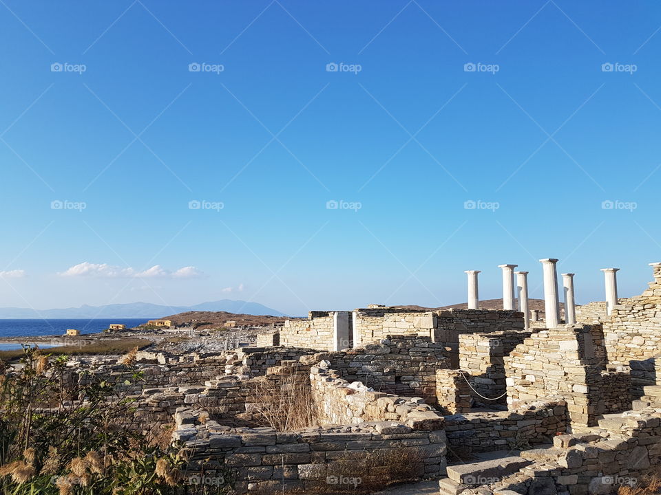 greece ados island greece near mykonos view of the beach and mythological sculpture