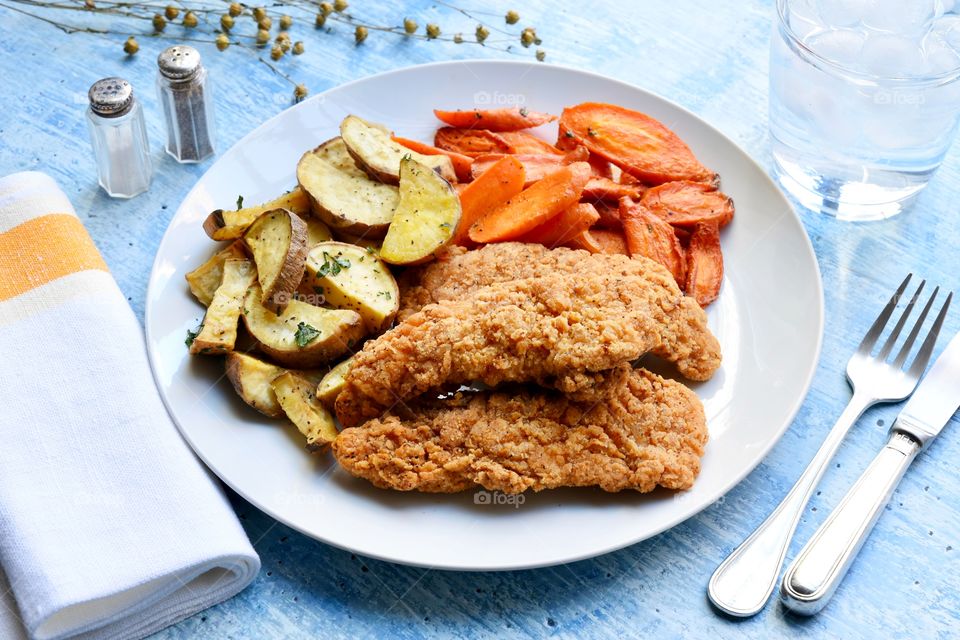 Chicken potatoes and carrots on a plate 