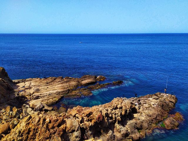 The photo of beach, sea, coast, water, nature, sand, rock, ocean, horizon, sunlight, morning, shore, wave, cliff, reflection, terrain, material, body of water, waves, wave of  wind