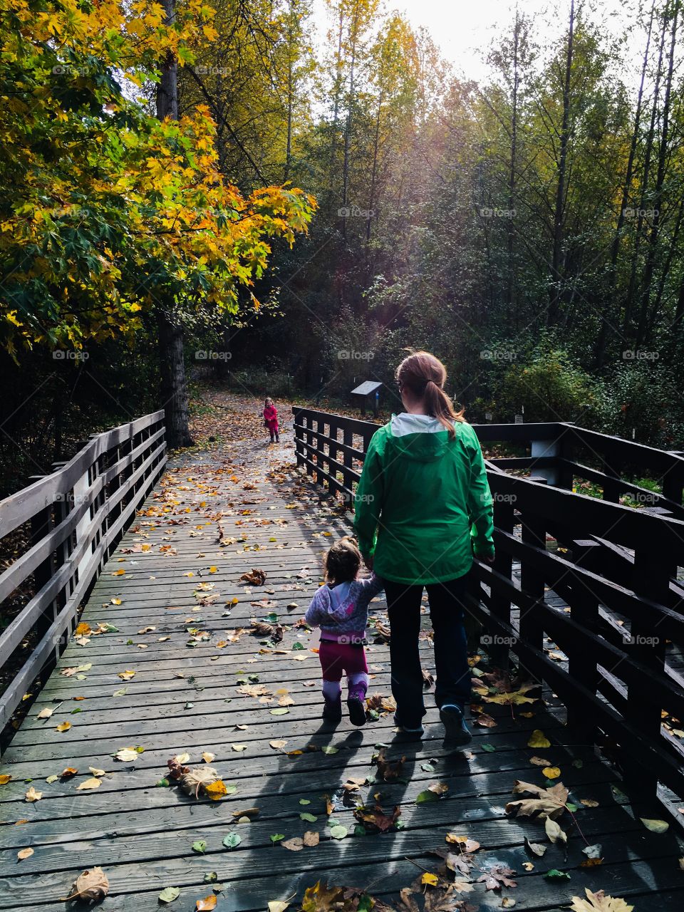 Mother and children walking in the forest