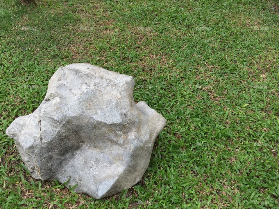 Granite stone on the green lawn