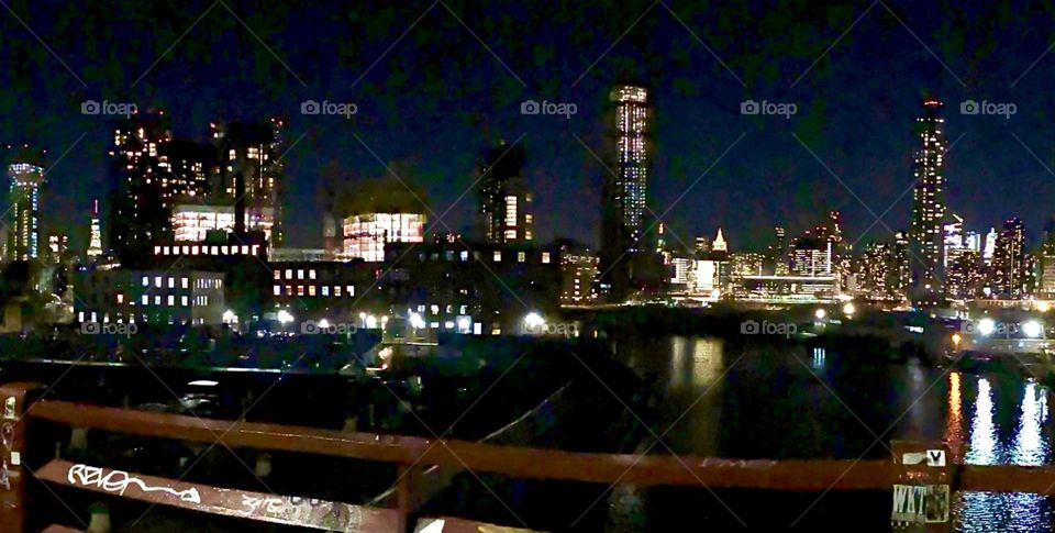 Newtown Creek and the “Long Island City” as well as the “Manhattan” skyline at night seen from the “Pulaski Bridge”. 2022. Hypnotic Productions
