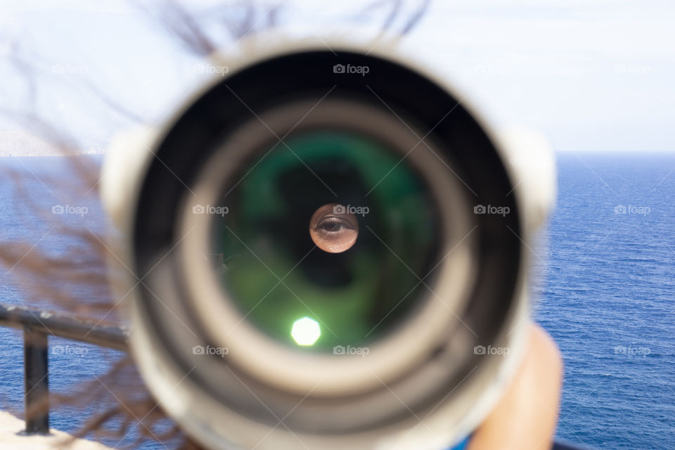 Girl looks through a spyglass