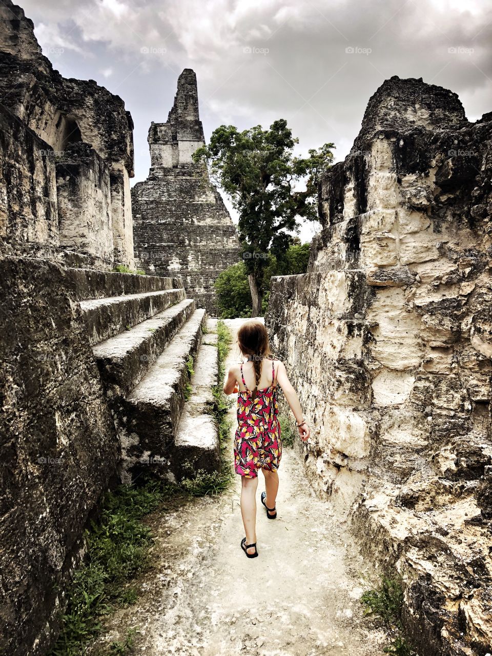 Child walking through Mayan ruins in Guatemala 