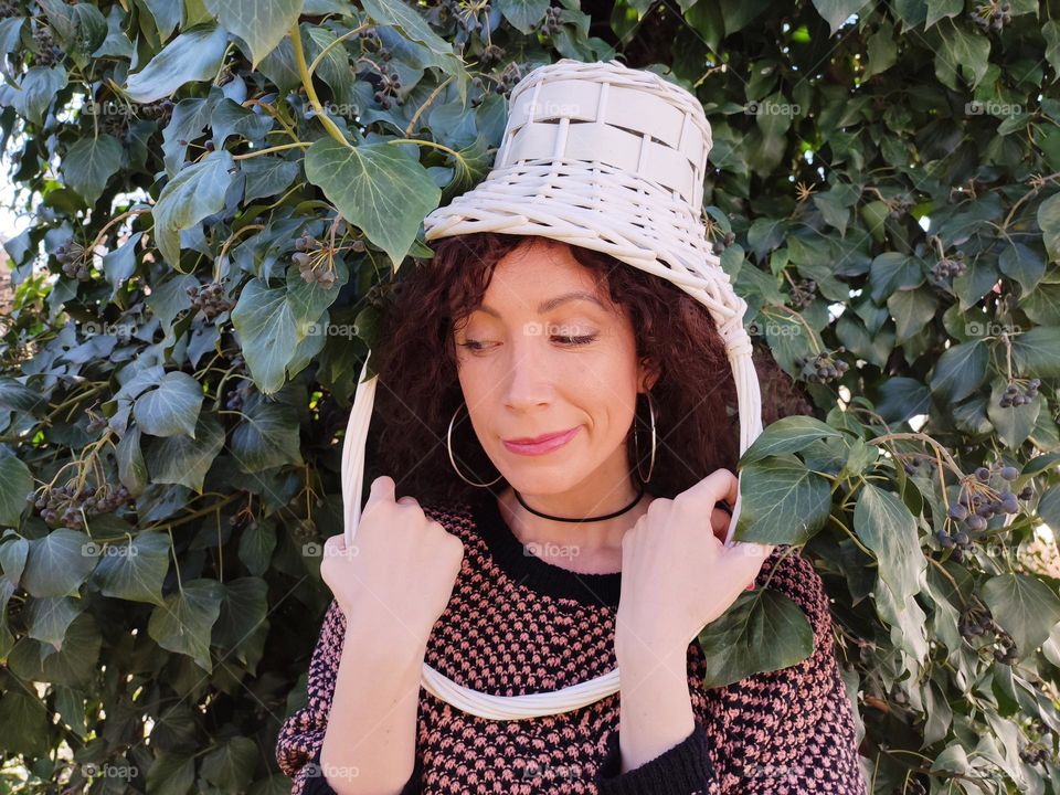 Funny Portrait of Young Woman Posing With Basket on Head, Smiling with Happy Face