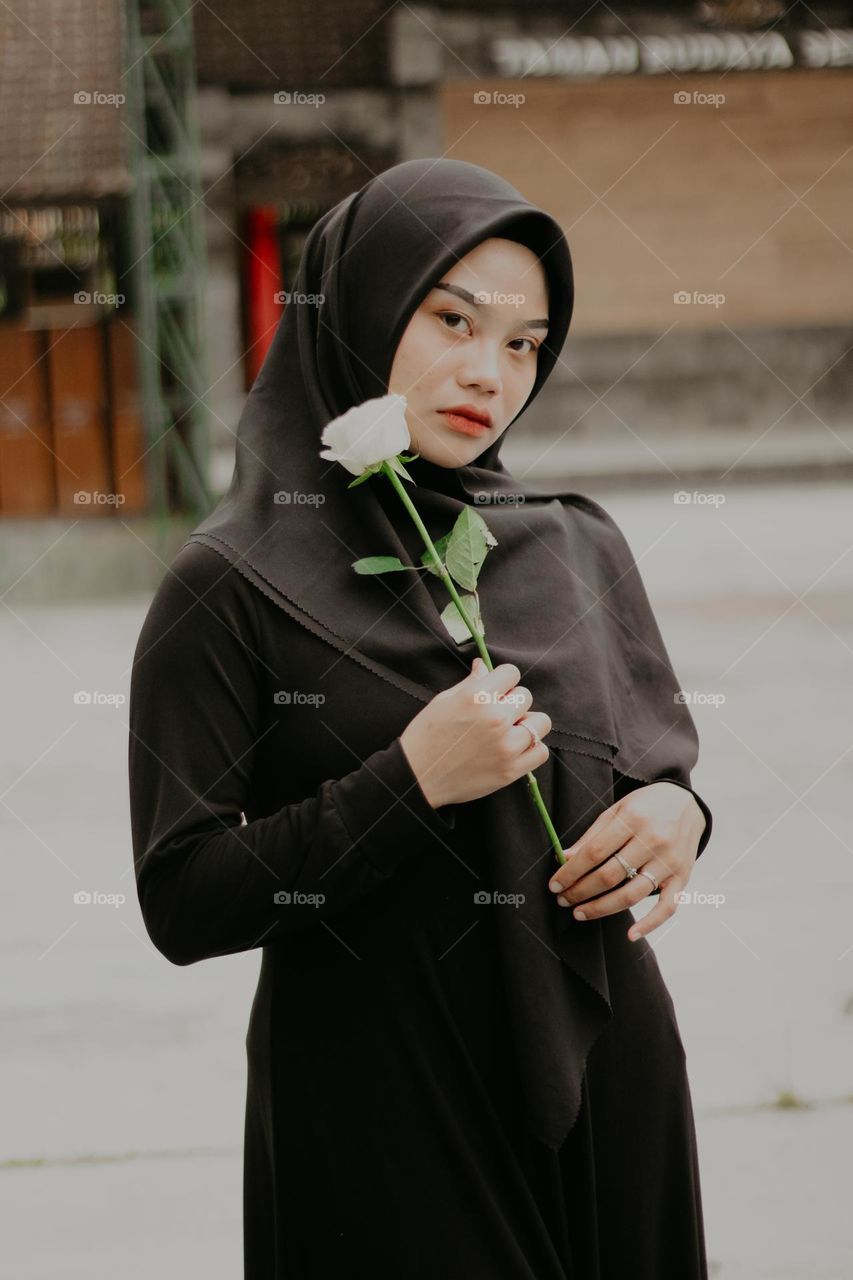 portrait of woman holding rose