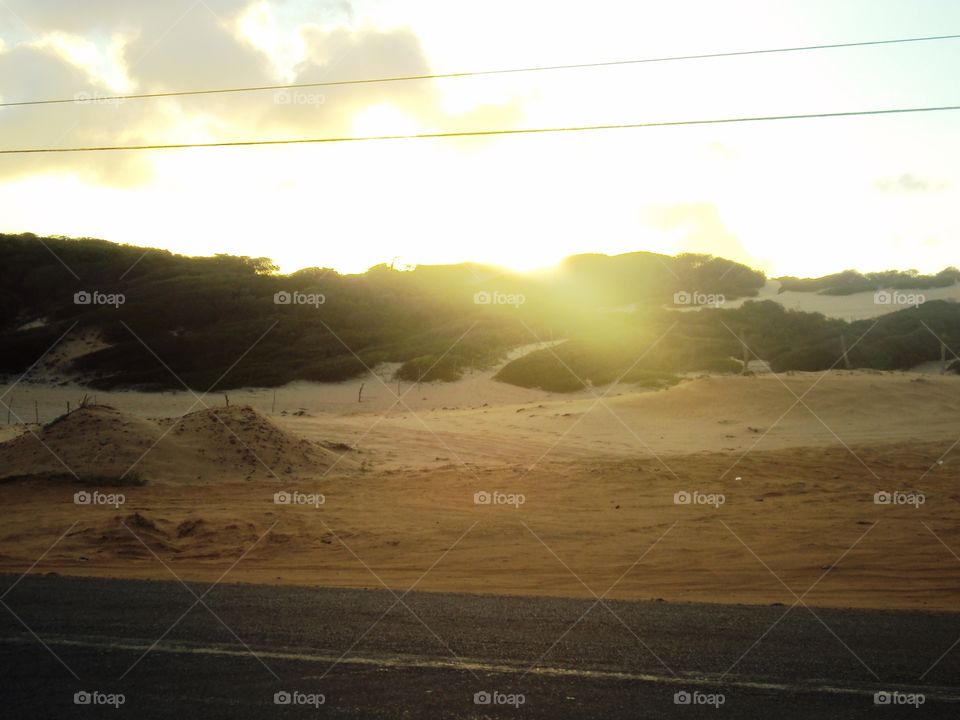 Sunset among the dunes, on the road of Paraiba, Brazil.