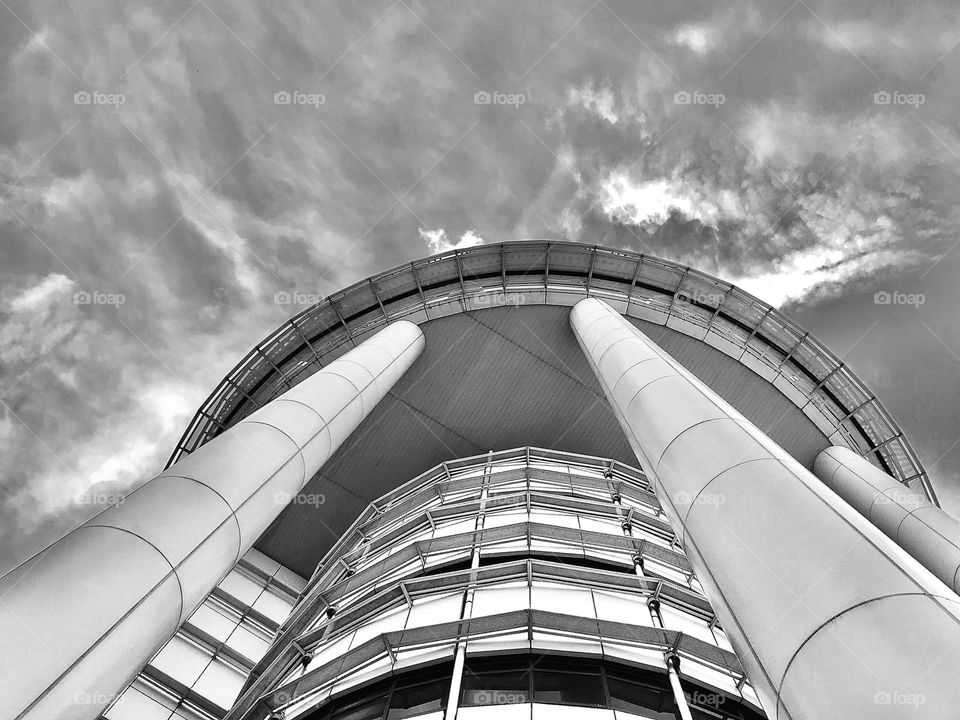 A building from ground to up towards sky in black and white picture.