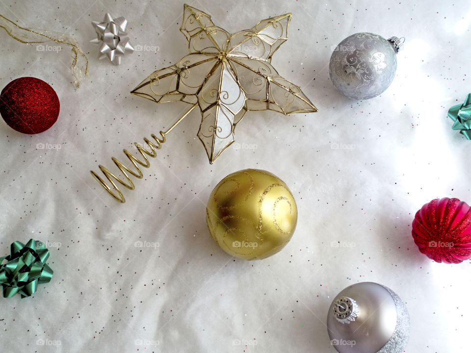 Christmas decorations on a white sparkly background.